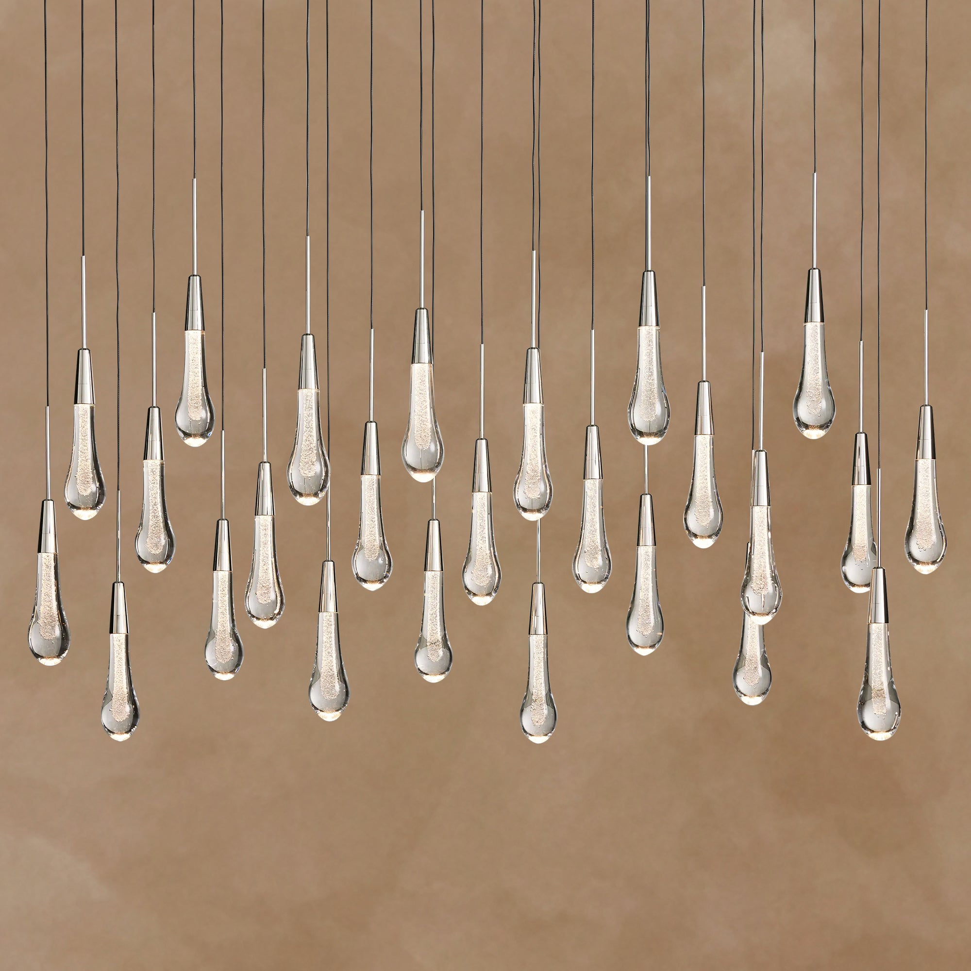 Chandelier with multiple hanging lampshades on a brown background